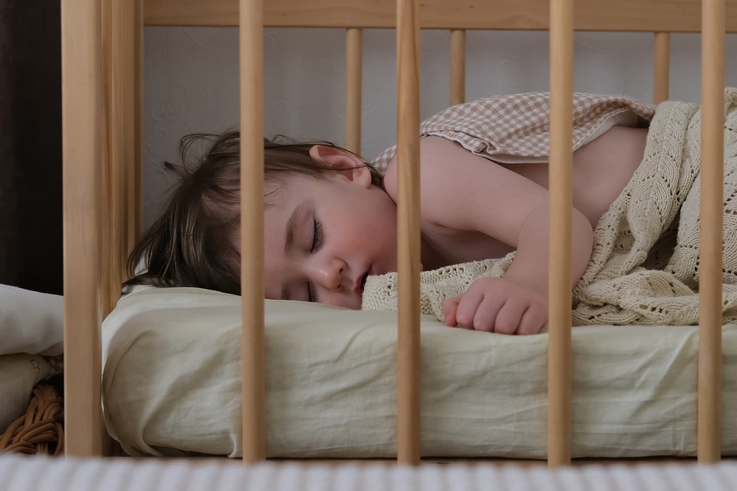 An image of a baby sleeping sweetly in a crib.